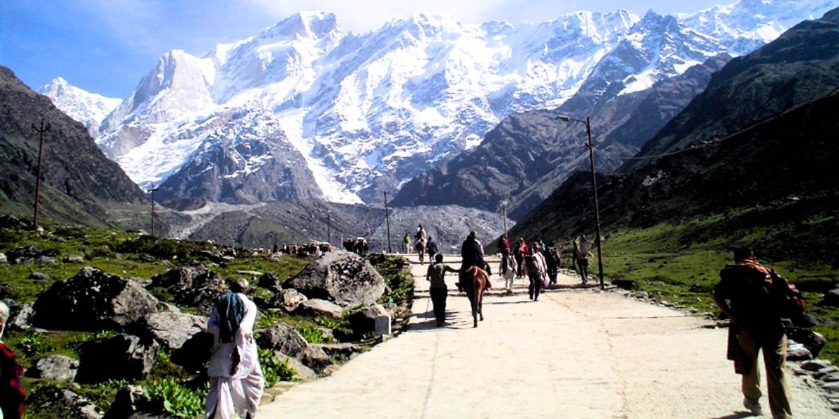 Pilgrims trekking steep Himalayan paths during Char Dham Yatra