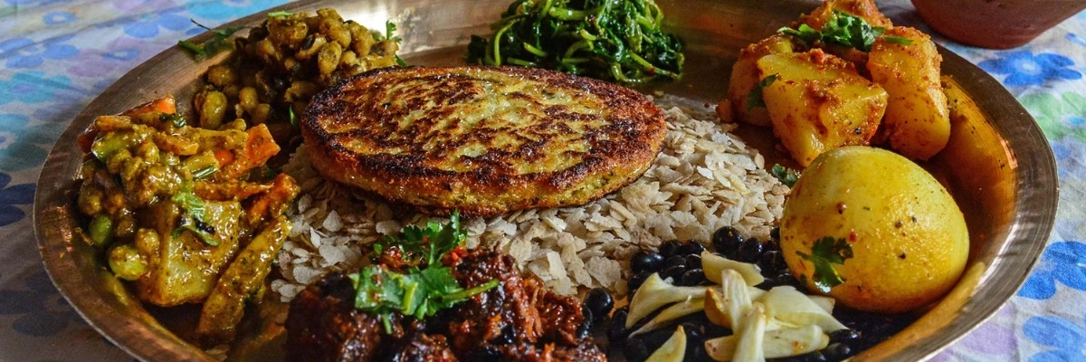 Plate of traditional Nepalese momo dumplings and dal bhat