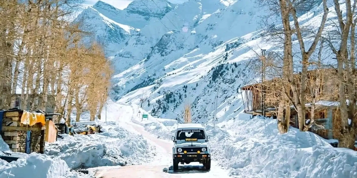 Mountain road leading to Spiti Valley with snow-capped peaks